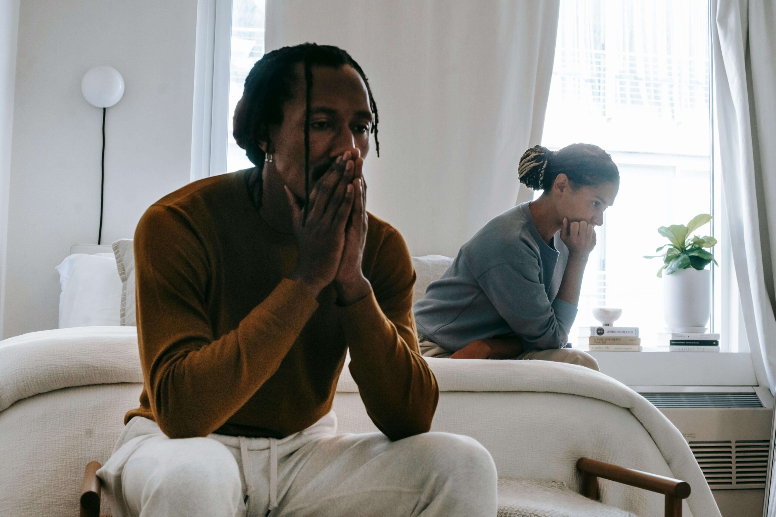 Couple sitting in silence, representing unmet expectations in relationships